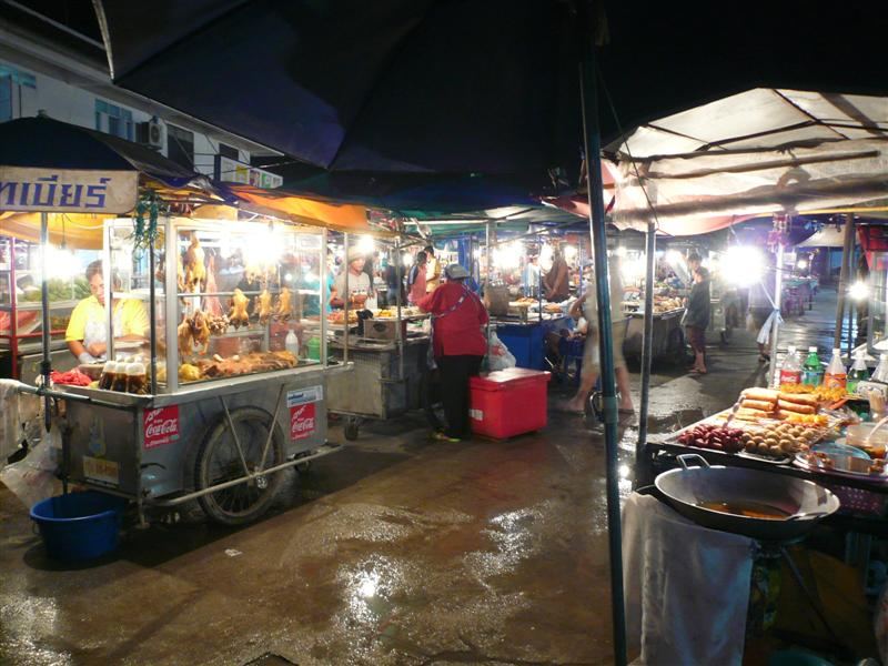 Food stalls with roast duck, grilled snacks and fried treats at the evening food market in Thong Sala, Koh Phangan