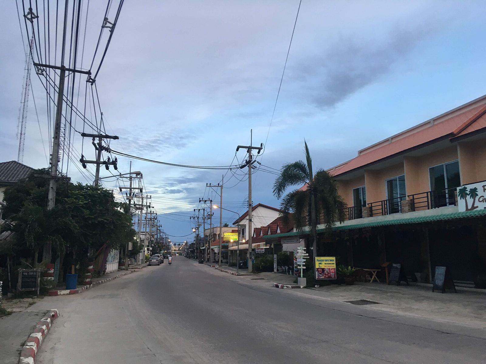 Quiet main road lined with shophouses in Thong Sala town, Koh Phangan, in the early morning